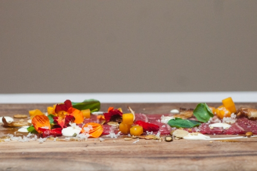 Australian Wagyu Carpaccio, Mushrooms, Squash Pickles, Nasturtiums, and Ranch from Levon Wallace of Proof on Main Australian Wagyu Carpaccio, Mushrooms, Squash Pickles, Nasturtiums, and Ranch