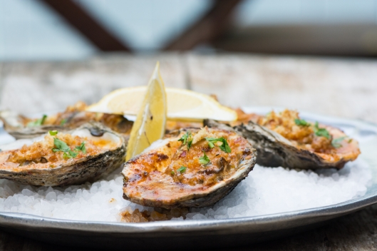 Barbecued Gulf Oysters, Chile-Garlic Butter, Parmesan, and Bread Crumbs from Chefs Kris Tominaga and Brian Dunsmoor of The Hart and the Hunter Barbecued Gulf Oysters, Chile-Garlic Butter, Parmesan, and Bread Crumbs
