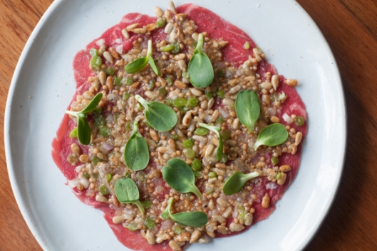 Australian Beef Carpaccio, Sunflower Seeds and Shoots and Garlic Confit 